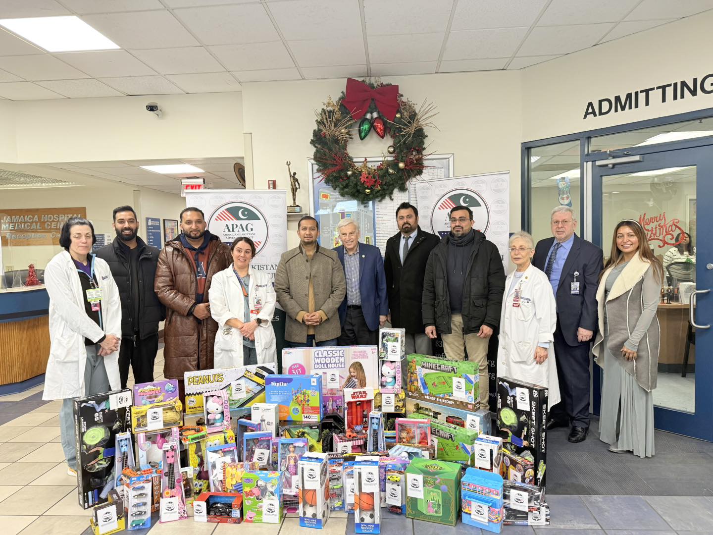 APAG Cares holiday toy drive with Santa and a child