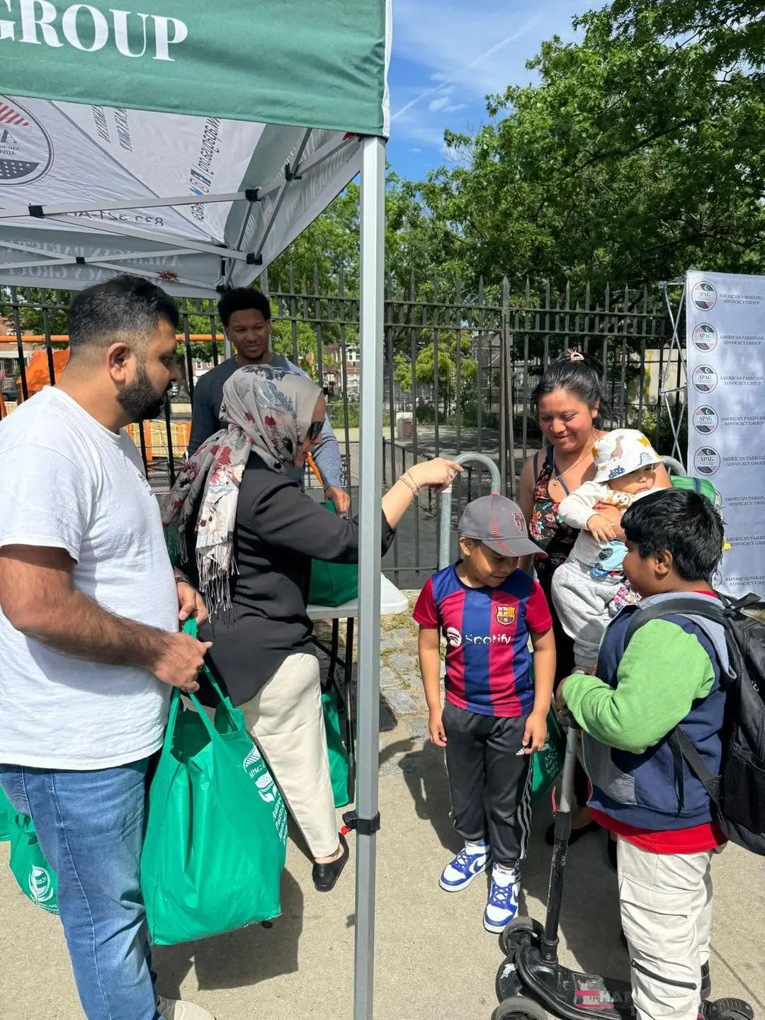 APAG Cares volunteers handing food bags to community members during Eid ul-Adha support