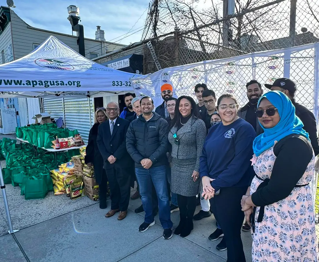 APAG Cares volunteers standing near prepared food bags during Ramadan support