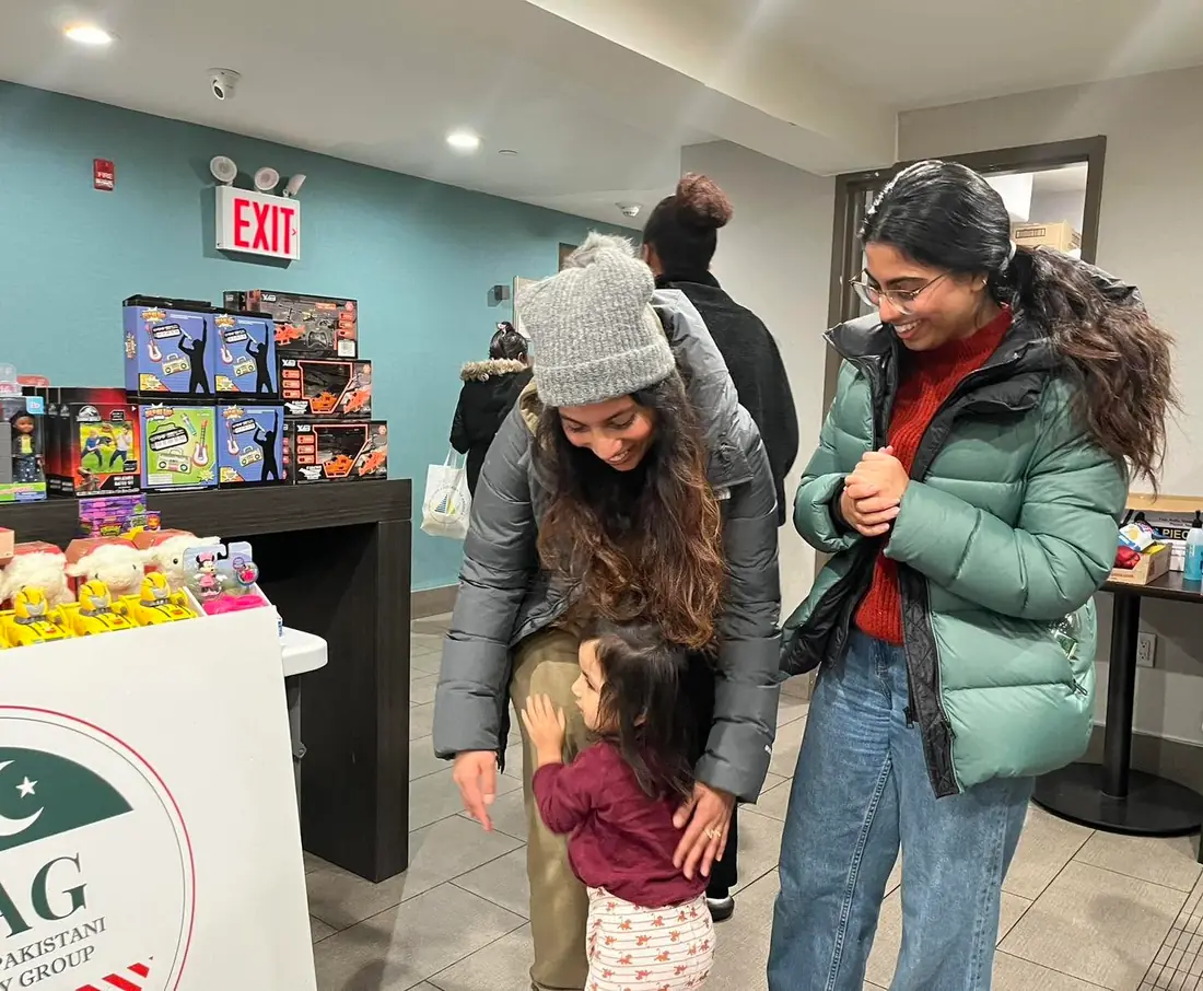 Children and families receiving holiday gifts through APAG Cares support