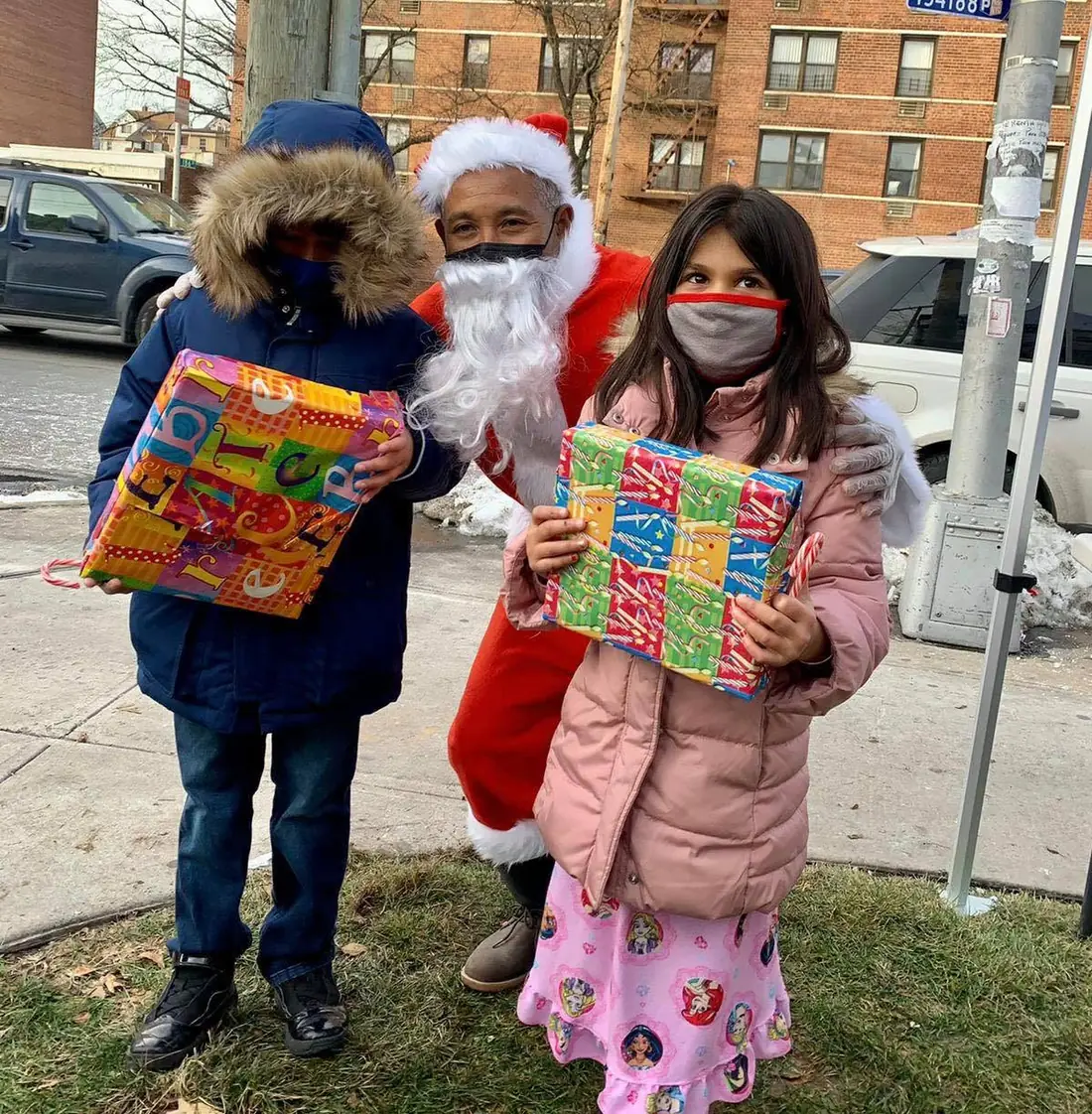Child receiving a gift during an APAG Cares holiday event