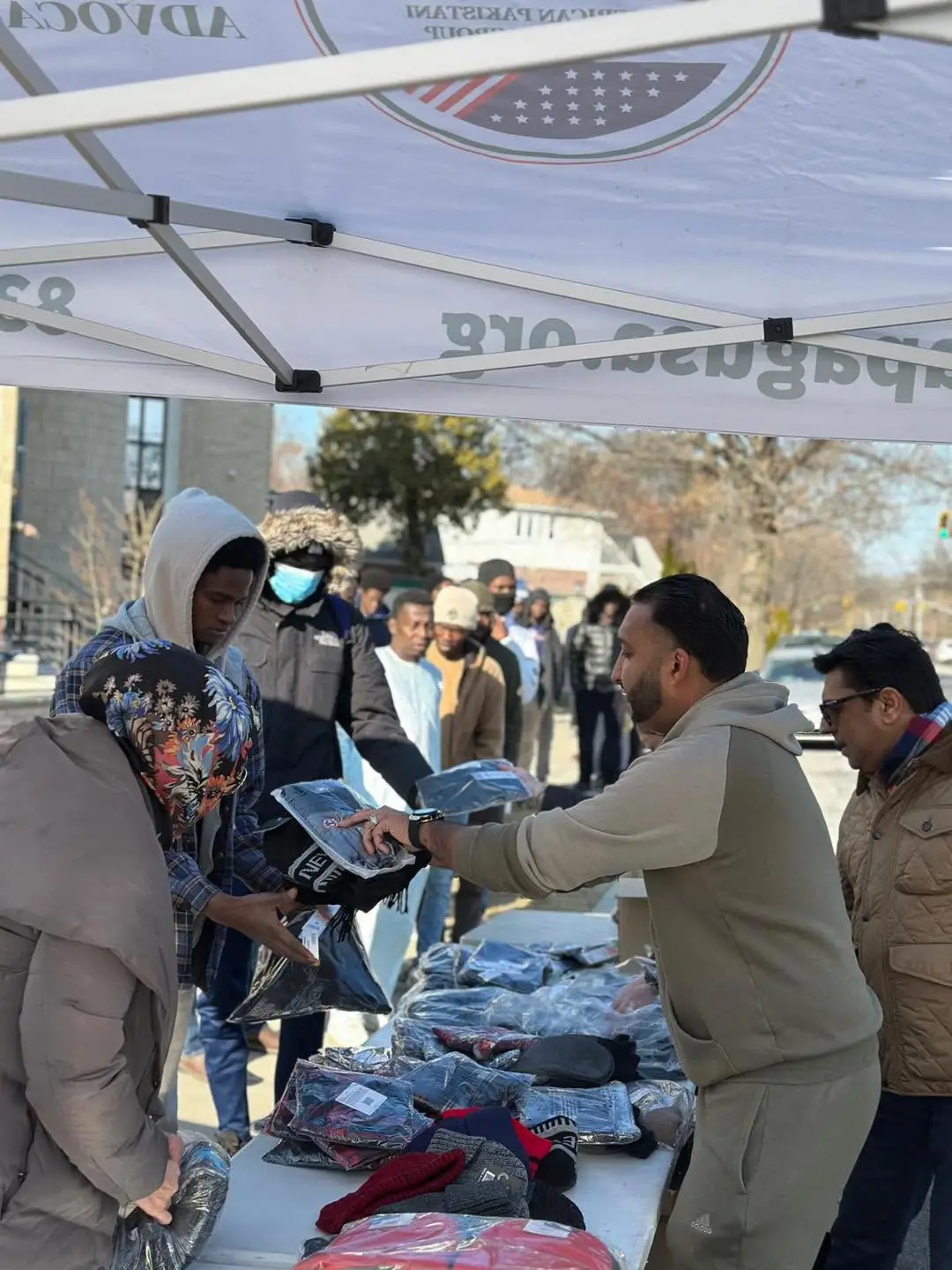 Volunteers distributing winter clothing during an APAG Cares community drive