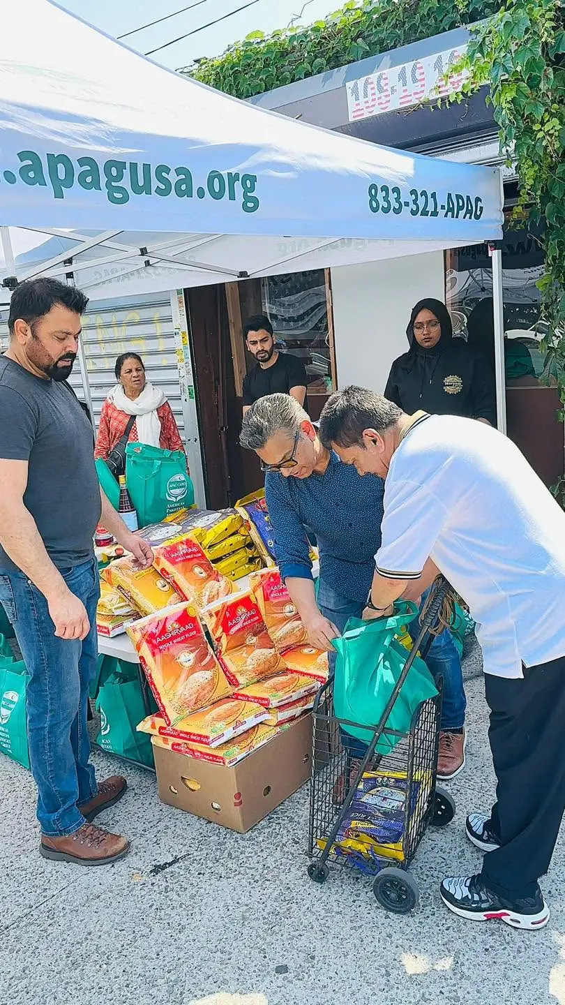 APAG Cares volunteers helping distribute food support to a community member
