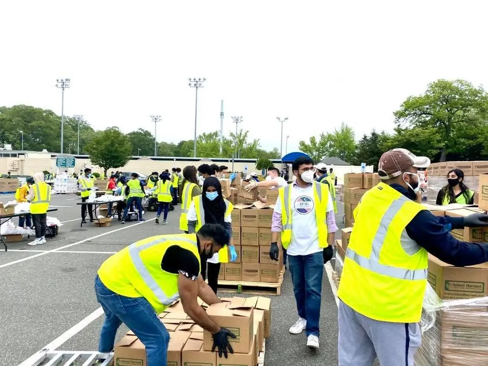 APAG Cares volunteers organizing food support during early community service work