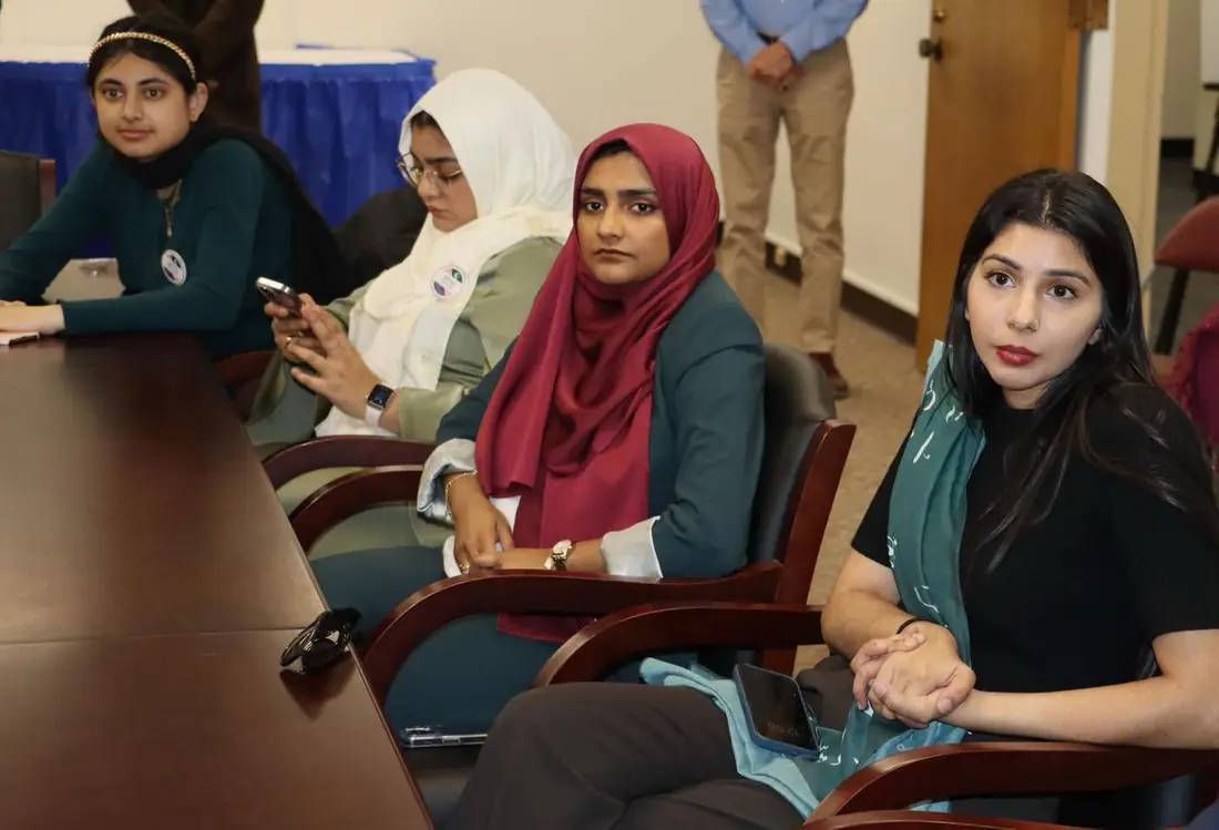 Women and young community members seated together during an APAG Cares gathering